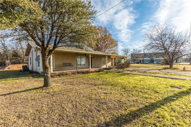 exterior space with a front lawn and central air condition unit