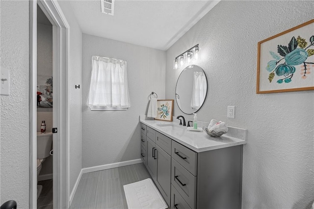 bathroom with vanity and toilet