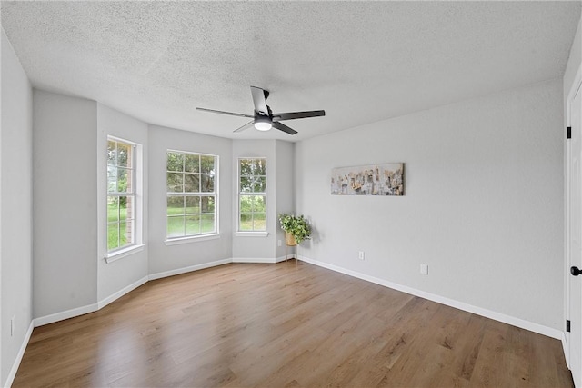 unfurnished room with ceiling fan, light hardwood / wood-style floors, and a textured ceiling