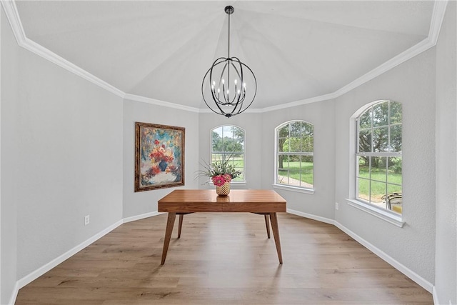 dining area with a chandelier, light wood-type flooring, vaulted ceiling, and crown molding