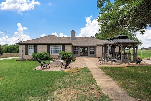 back of house featuring a fire pit, french doors, a gazebo, a yard, and a patio