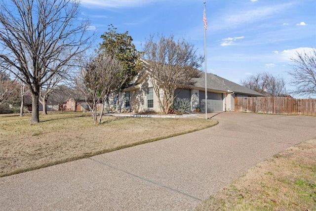 ranch-style house featuring a front lawn and a garage