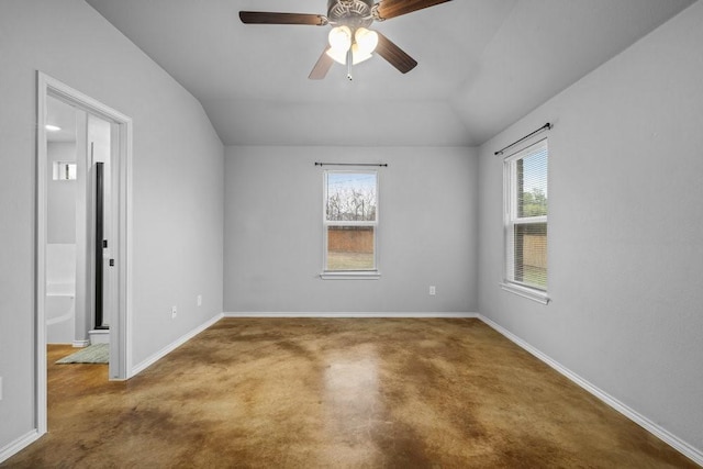 spare room with ceiling fan, carpet floors, and vaulted ceiling