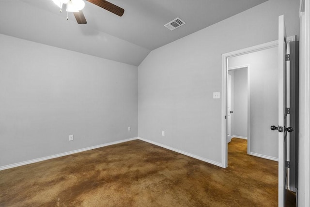 empty room featuring ceiling fan, dark carpet, and vaulted ceiling