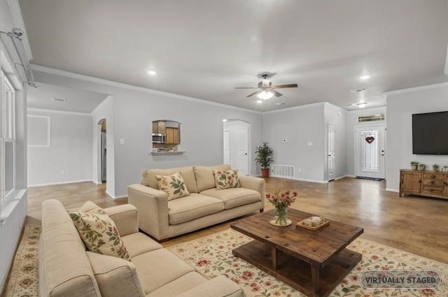 living room featuring crown molding and ceiling fan