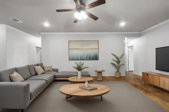 living room with hardwood / wood-style flooring, ceiling fan, and ornamental molding