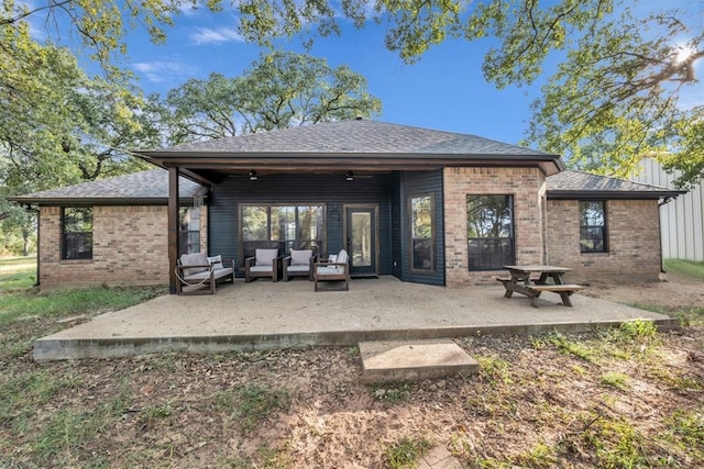 back of property featuring a patio and outdoor lounge area