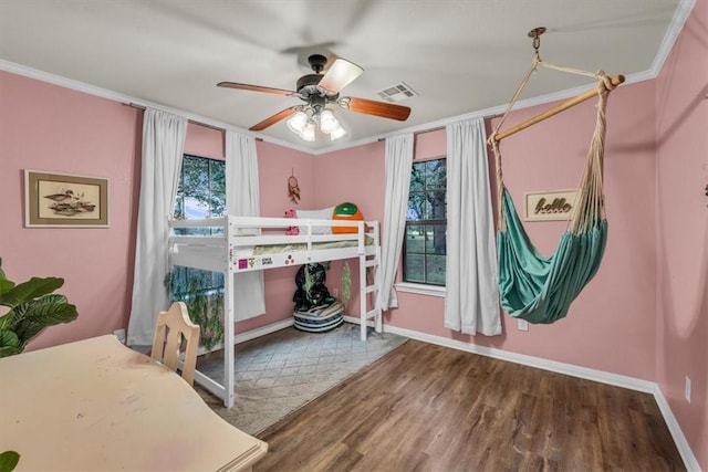 bedroom featuring hardwood / wood-style floors, ceiling fan, and ornamental molding