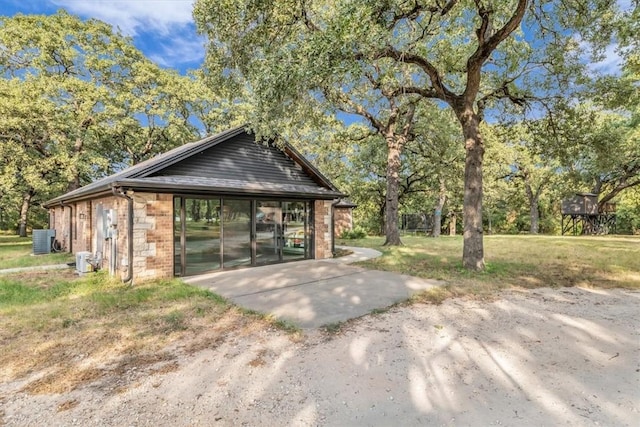 view of outbuilding with a yard and cooling unit