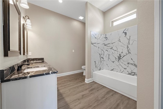 full bathroom featuring hardwood / wood-style floors, vanity, toilet, and  shower combination