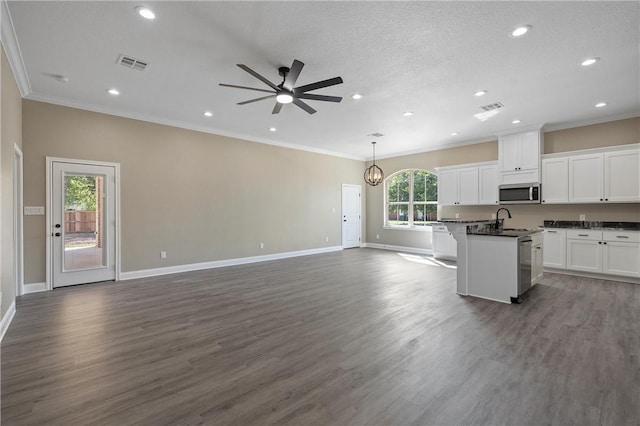 kitchen with decorative light fixtures, a healthy amount of sunlight, white cabinetry, and dark hardwood / wood-style floors