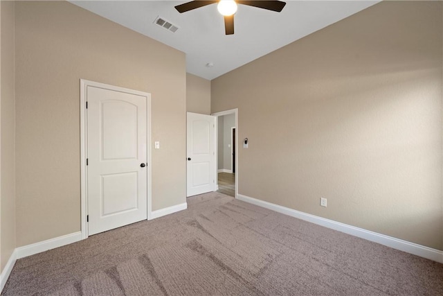 unfurnished bedroom featuring ceiling fan and carpet