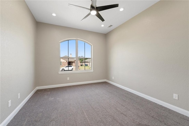 carpeted spare room with ceiling fan