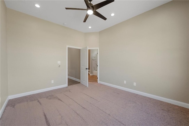 spare room with light carpet and ceiling fan