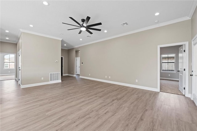 unfurnished living room featuring crown molding, a healthy amount of sunlight, and light hardwood / wood-style floors