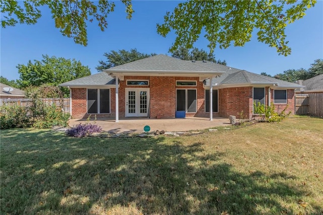 rear view of property with a patio area, a yard, and french doors