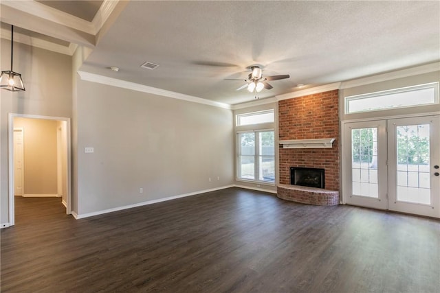 unfurnished living room with ceiling fan, dark hardwood / wood-style flooring, a healthy amount of sunlight, and a brick fireplace