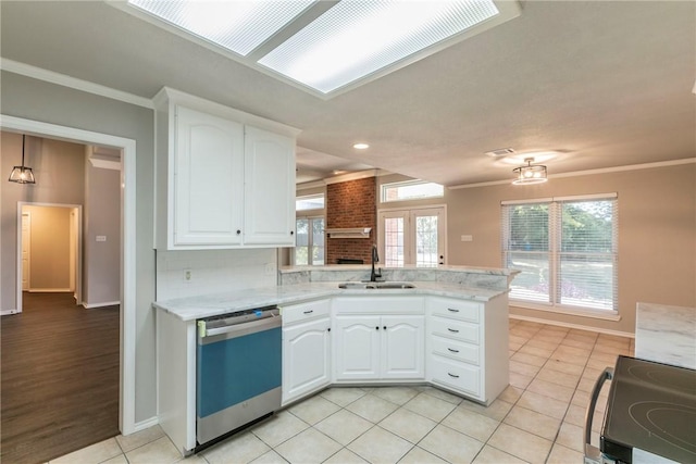 kitchen featuring white cabinets, stove, kitchen peninsula, and stainless steel dishwasher