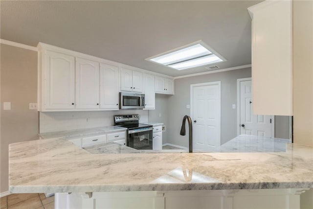 kitchen featuring white cabinetry, light stone countertops, kitchen peninsula, and stainless steel appliances