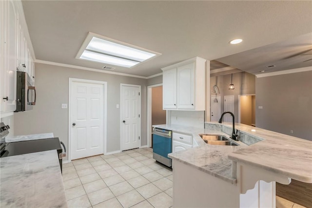 kitchen with sink, appliances with stainless steel finishes, white cabinetry, light stone counters, and kitchen peninsula