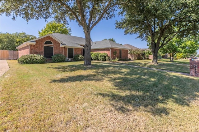 single story home featuring a front lawn