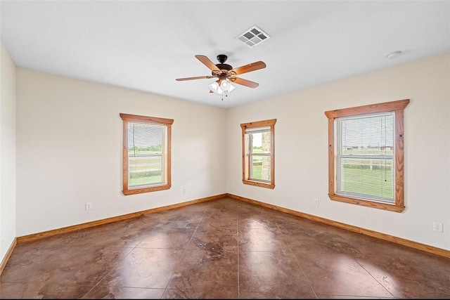 spare room with ceiling fan and a healthy amount of sunlight