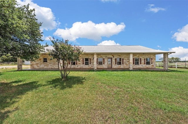 rear view of house featuring a lawn