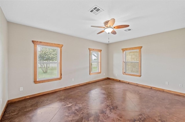 tiled spare room featuring ceiling fan