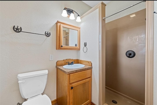 bathroom with walk in shower, vanity, and toilet