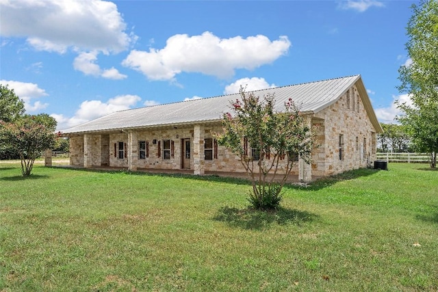 rear view of house featuring a lawn