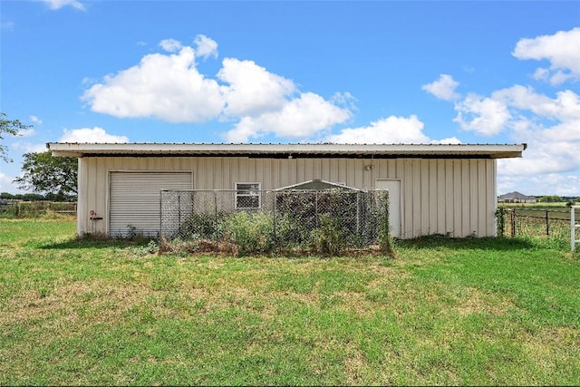 view of outbuilding featuring a lawn