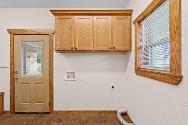 clothes washing area with cabinets, washer hookup, tile patterned floors, and electric dryer hookup