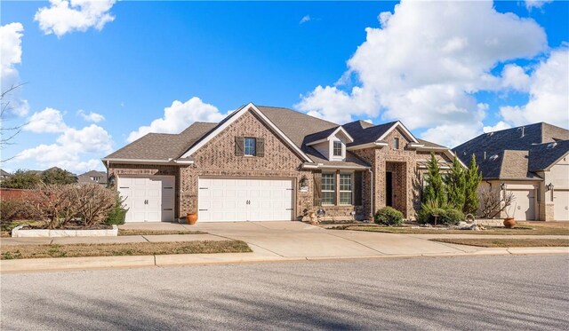 view of front of house with brick siding and driveway