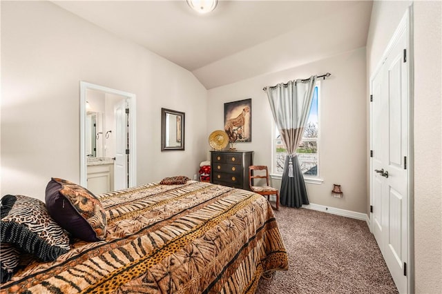 bedroom with baseboards, ensuite bath, carpet flooring, and vaulted ceiling