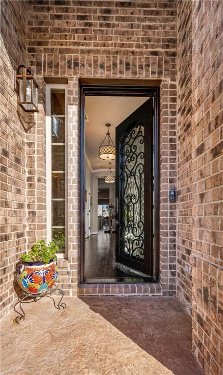 view of exterior entry with brick siding