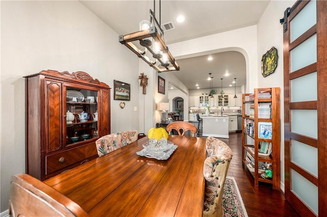 dining room featuring recessed lighting, visible vents, arched walkways, and dark wood finished floors