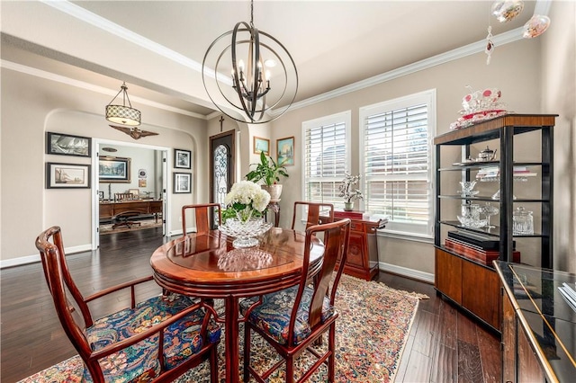 dining area featuring crown molding, baseboards, dark wood-type flooring, and a chandelier