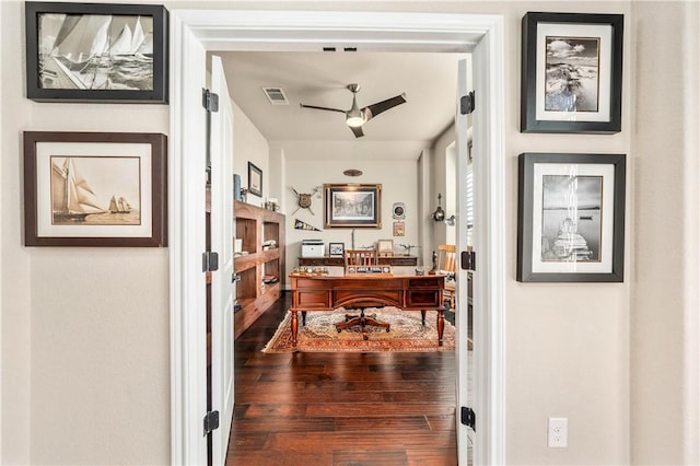 office area featuring hardwood / wood-style floors, a ceiling fan, and visible vents