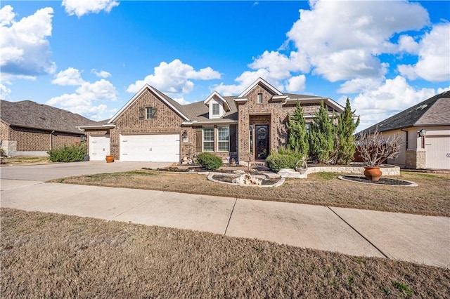 view of front of house featuring brick siding, an attached garage, and driveway