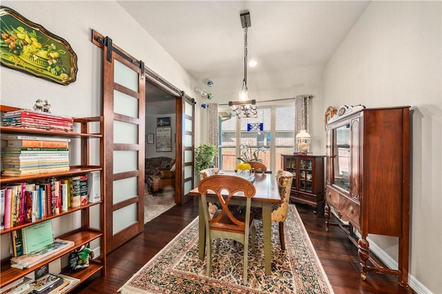 dining space featuring a barn door, baseboards, and dark wood-style flooring