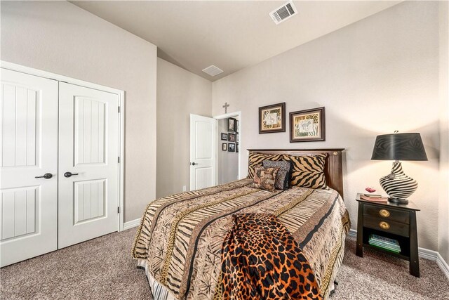 bedroom with visible vents, baseboards, vaulted ceiling, carpet floors, and a closet