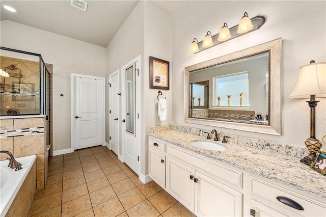 full bathroom with visible vents, a stall shower, tile patterned flooring, a bath, and vanity