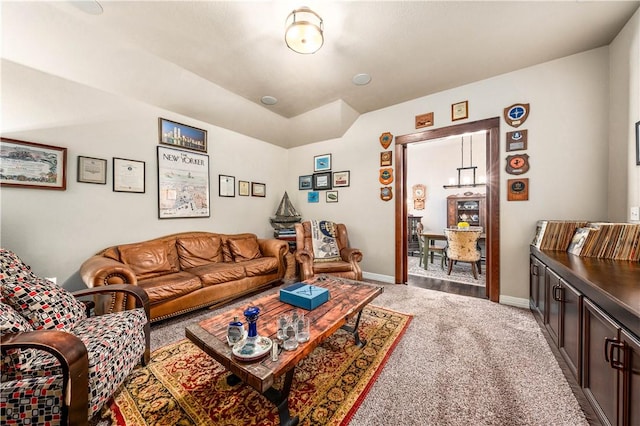 living area featuring carpet and baseboards