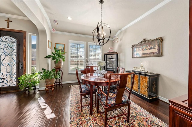 dining space featuring a notable chandelier, dark wood-style floors, and crown molding