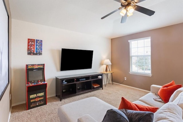 carpeted living room featuring ceiling fan and baseboards