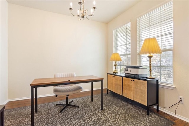 home office featuring an inviting chandelier, baseboards, and dark wood finished floors