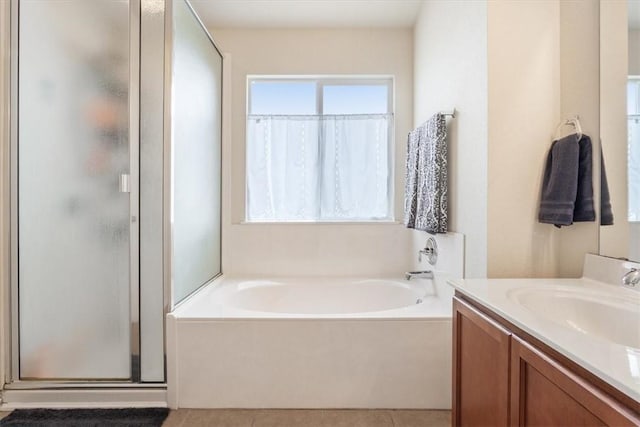 full bath featuring tile patterned floors, vanity, a shower stall, and a bath