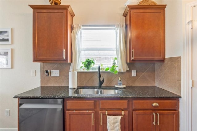 kitchen with dark stone counters, stainless steel dishwasher, backsplash, and a sink