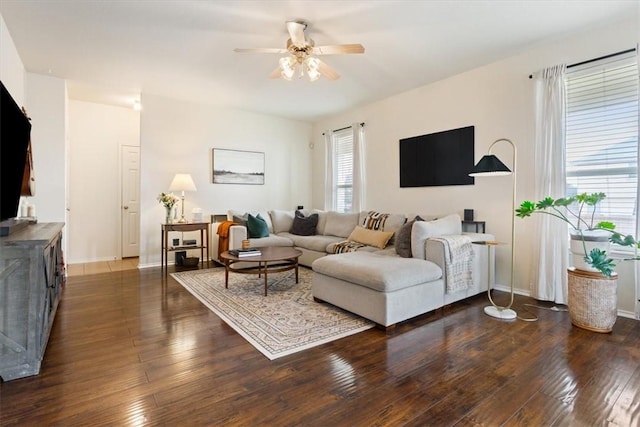 living room with ceiling fan, dark wood finished floors, and a healthy amount of sunlight