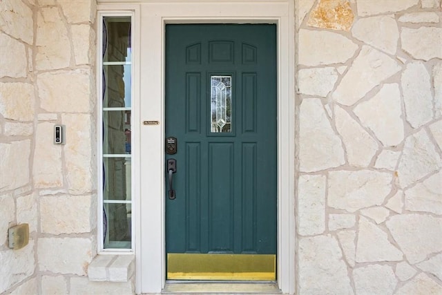 property entrance with stone siding